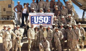 Members of the United Service Organization’s (USO) Operation Starflight Freedom Tour Actors Dennis Farina, Cheryl Ladd and Sherri Saum pose for a photograph with US Army Soldiers assigned to Delta 6/52 Air Defense Artillery (ADA) at Prince Sultan AB, Saudi Arabia.